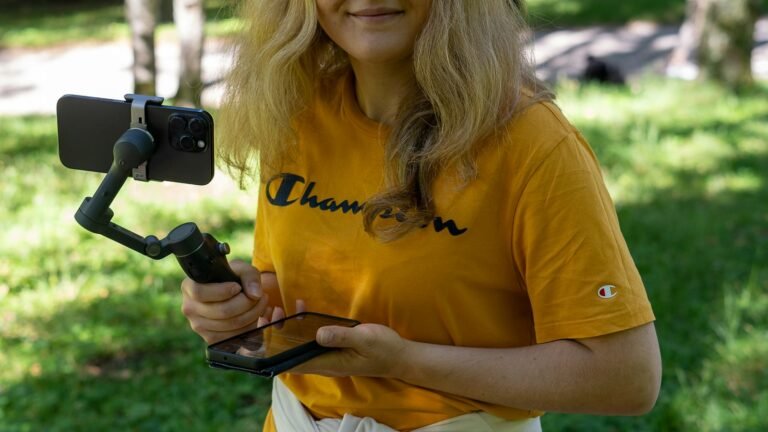 Vidéaste filmant avec un smartphone sur stabilisateur
